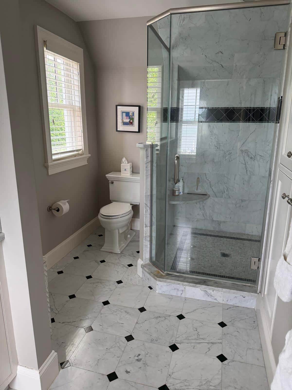Glass shower and marble bathroom detailed during a deep cleaning