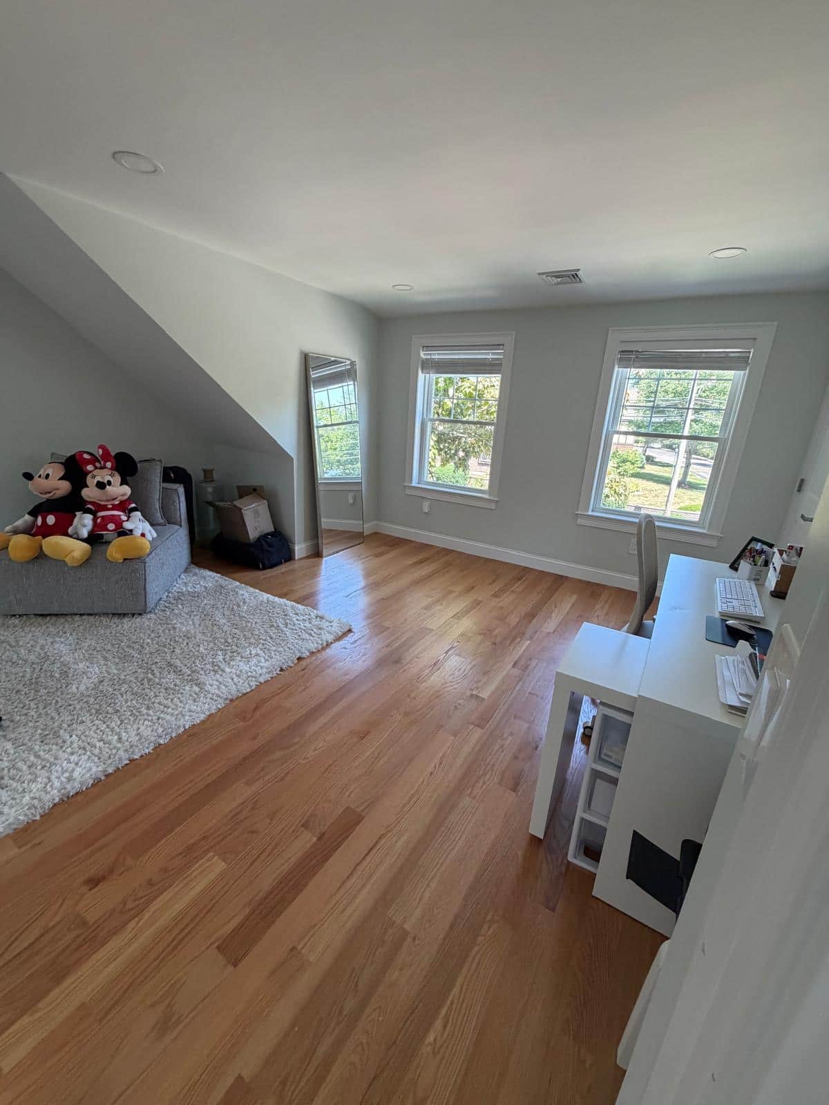 Bonus room with hardwood floors and a play area after a cleaning visit