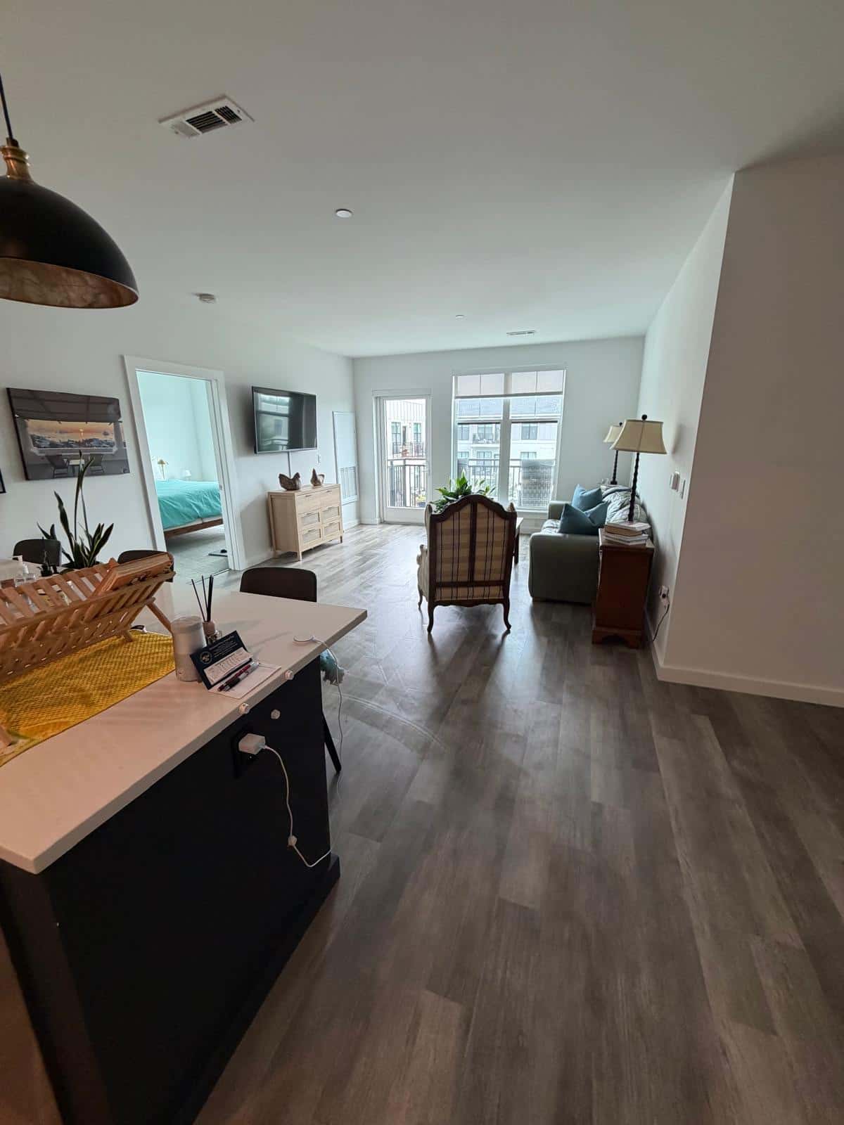 Open plan condo living and dining area with plank floors after cleaning