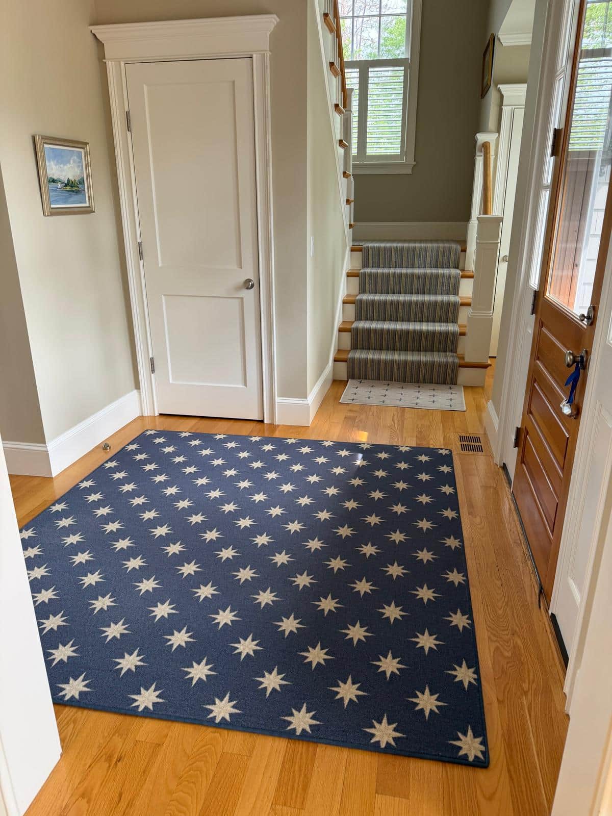 Entryway and staircase with clean hardwood floors