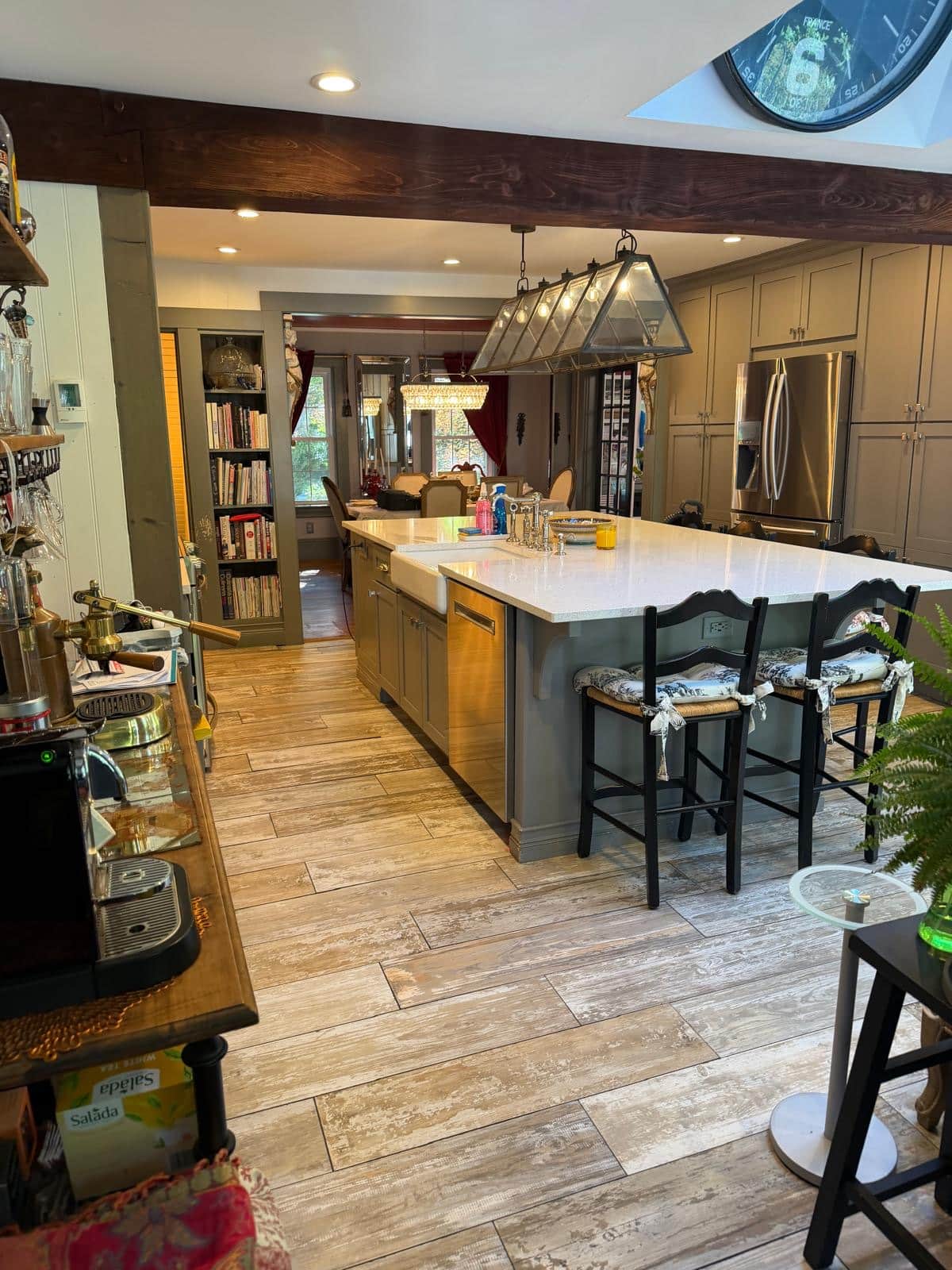 Kitchen with exposed beam, large island and farmhouse sink after cleaning