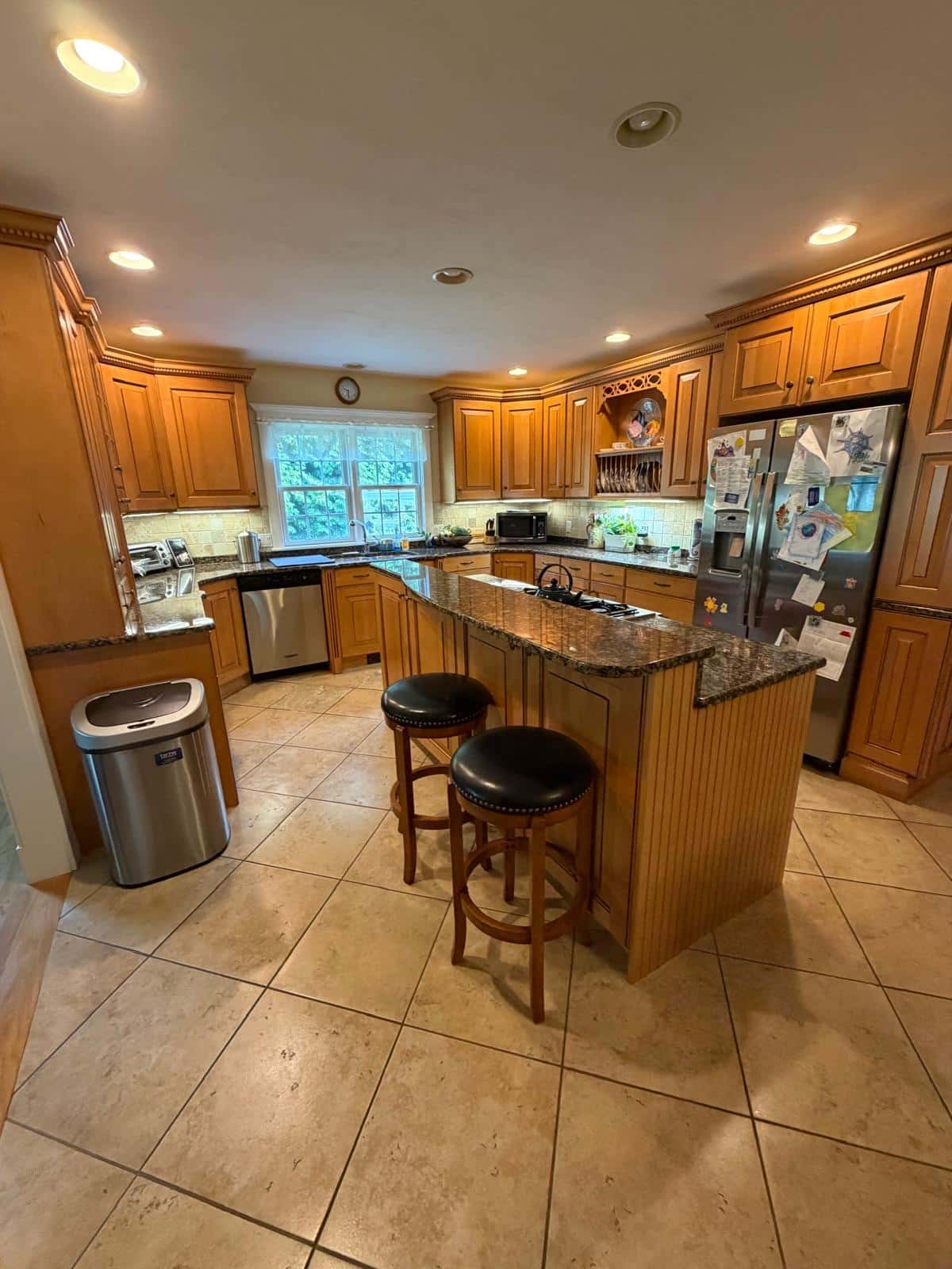 Kitchen with granite island and breakfast bar seating after a deep cleaning