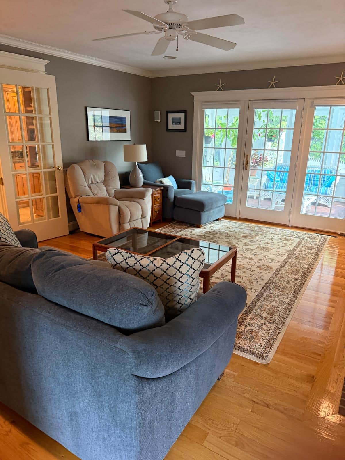 Living room with French doors opening to a porch after a cleaning visit