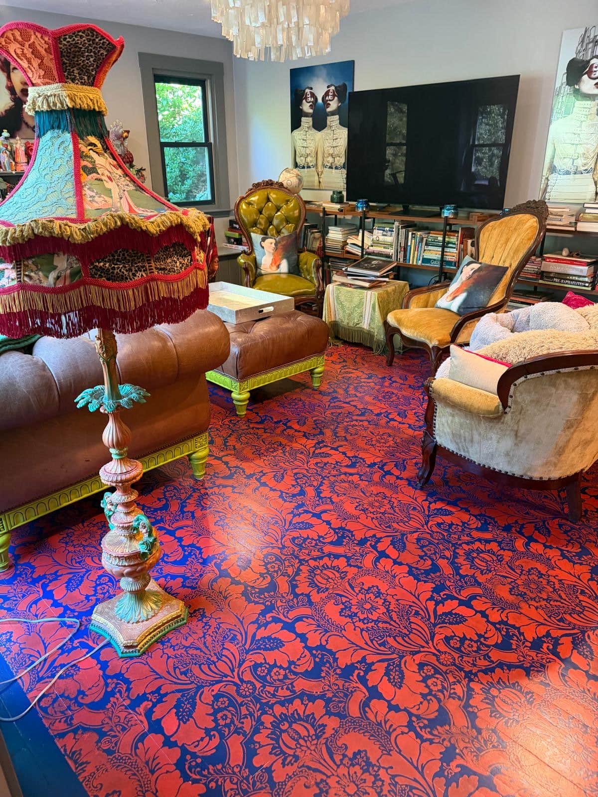 Eclectic living room with a hand-painted floor, antique chairs and velvet upholstery
